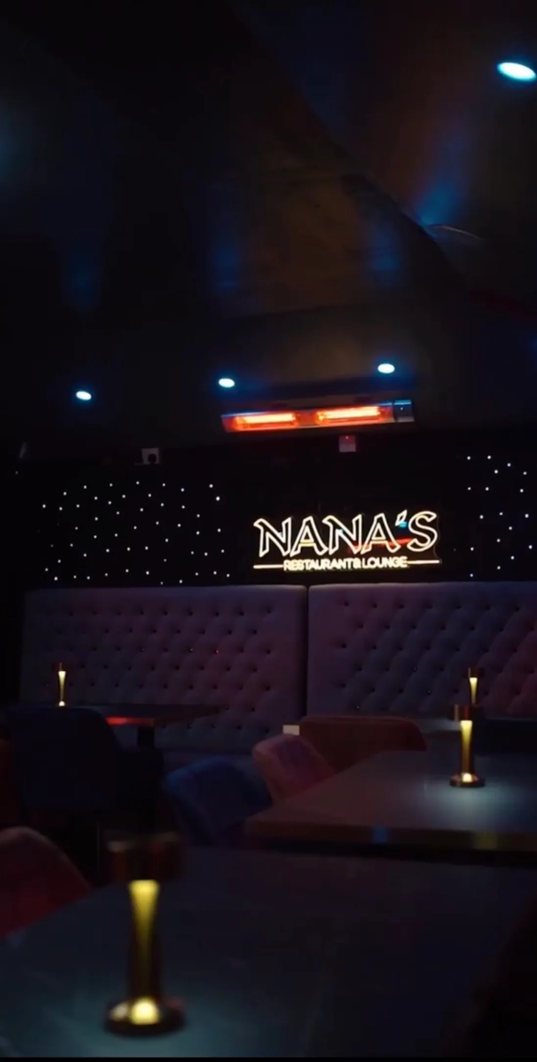 The lounge with its tiled floor, fairy lights and greenery